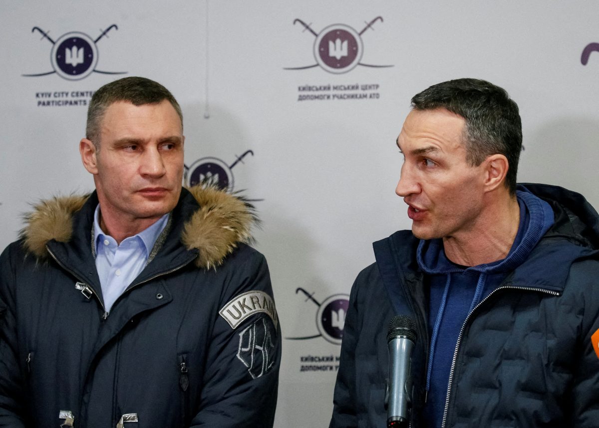 FILE PHOTO: Ukrainian heavyweight boxing world champion Wladimir Klitschko who joined the Ukrainian Territorial Defence Forces and his brother, Mayor of Kyiv and former heavyweight boxing champion Vitaly Klitschko, speak with journalists during the opening of the first Ukrainian Territorial Defence Forces recruitment centre in central Kyiv, Ukraine, February 2, 2022. REUTERS/Gleb Garanich/File Photo