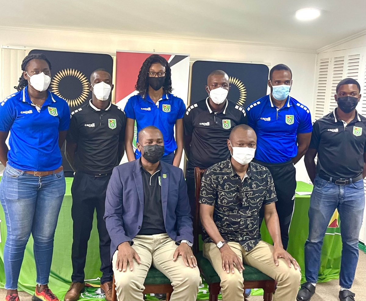 GFF President Wayne Forde (sitting left) and GFF Executive Committee Member and Head of Refereeing Dion Inniss (sitting right) posing for a photo opportunity alongside several officials inclusive of FIFA referees Kleon Lindey (2nd from left) and Sherwin Johnson (4th from left) 