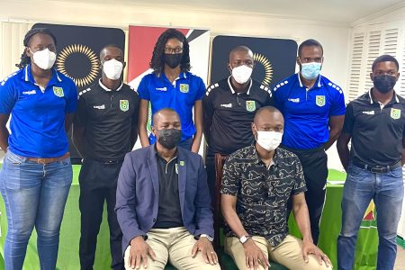GFF President Wayne Forde (sitting left) and GFF Executive Committee Member and Head of Refereeing Dion Inniss (sitting right) posing for a photo opportunity alongside several officials inclusive of FIFA referees Kleon Lindey (2nd from left) and Sherwin Johnson (4th from left) 