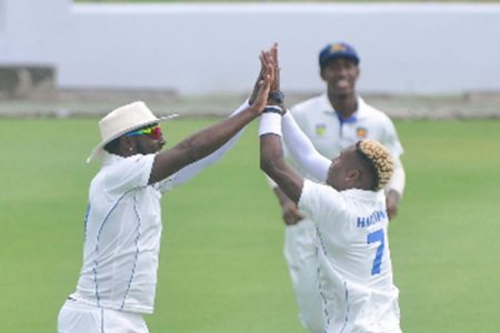 Fast bowler Keon Harding (right) celebrates a wicket with teammate Raymon Reifer at Kensington Oval yesterday. (Photo courtesy CWI Media) 