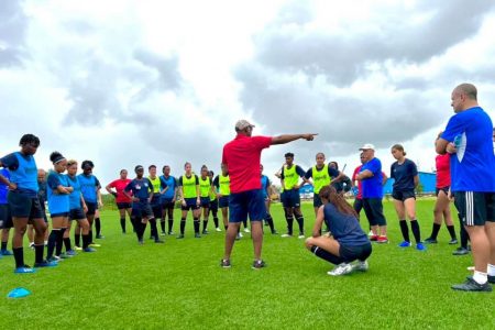 Lady Jaguars head-coach Dr Ivan. Joseph discussing a tactical move with members of his provisional squad at the National Training Centre, Providence.