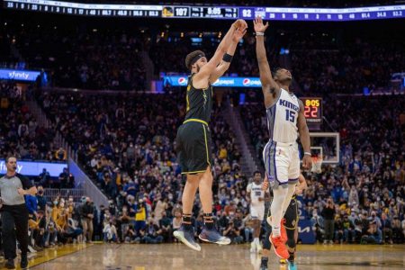 Golden State Warriors guard Klay Thompson (11) shoots a three point basket during the fourth quarter against Sacramento Kings guard Davion Mitchell (15) at Chase Center. Mandatory Credit: Neville E. Guard-USA TODAY Sports
