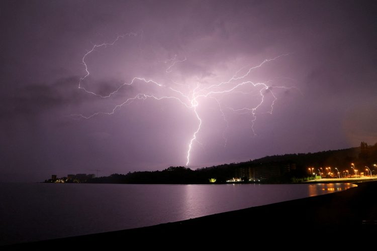 Lightning strikes are seen above Villarrica lake, in Villarrica, Chile, December 7, 2021. REUTERS/Cristobal Saavedra Escobar/