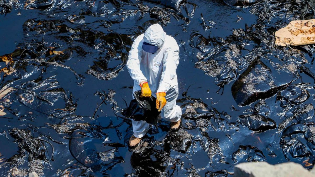 Oil spill clean-up on a beach in Peru
