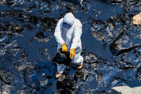 Oil spill clean-up on a beach in Peru