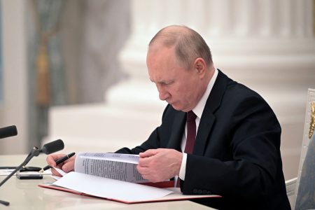 Russian President Vladimir Putin signs documents, including a decree recognising two Russian-backed breakaway regions in eastern Ukraine as independent entities, during a ceremony in Moscow, Russia, in this picture released February 21, 2022. Sputnik/Alexey Nikolsky/Kremlin via REUTERS