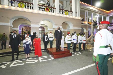 Republic anniversary: President Irfaan Ali (on dais) taking the salute at last night’s 52nd Republic Anniversary observance in the compound of the public buildings. (Facebook page of President Irfaan Ali)