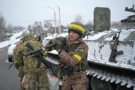Ukrainian servicemen stand guard on a road in Kharkiv, February 25. REUTERS/Maksim Levin