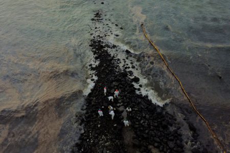 Workers clean the beach near Repsol's La Pampilla refinery after the recent oil spill that has caused an ecological disaster on the coast of Lima, in Ventanilla, Peru January 29, 2022. Picture taken with a drone. REUTERS/Angela Ponce 