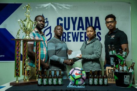 Co-Organiser Virgil Watts (2nd left) receives the sponsor’s cheque from Guyana Breweries Inc Marketing Manager, Melinda Telesford. Also in the photo is Seweon McGarrell, Head of Trade Marketing (1st right) and Co-Organiser Lynton Luke, head of Cool Crew Promotion.