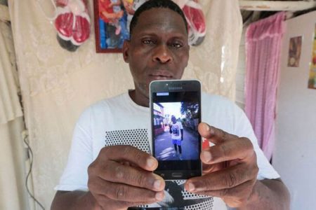Alcide Firdo, 47, shows a picture of his son Jaime Firdo during an interview with Reuters in Havana, Cuba, March 17, 2022. REUTERS/Stringer 