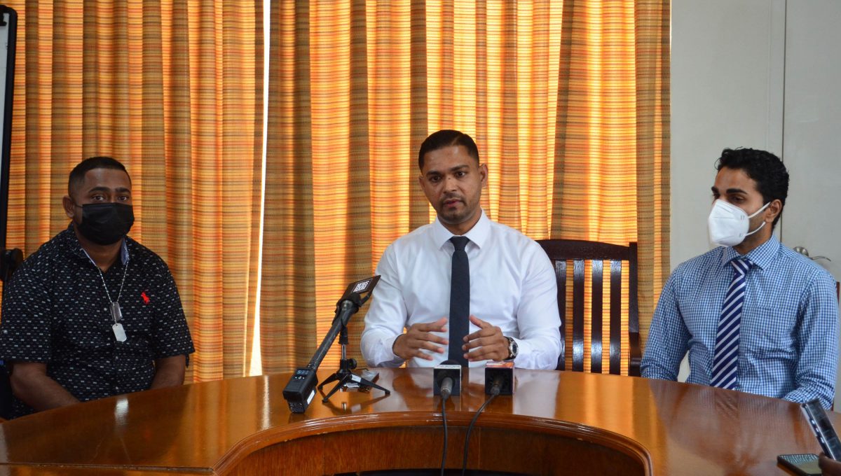 Police Corporal Amit Bacchus (at left) with Neurosurgeon Dr Amarnauth Dukhi (centre) and Management Consultant of the Woodlands Hospital Vilas Gobin at yesterday’s press conference (Orlando Charles photo)