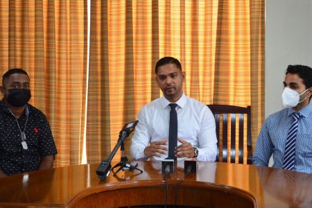 Police Corporal Amit Bacchus (at left) with Neurosurgeon Dr Amarnauth Dukhi (centre) and Management Consultant of the Woodlands Hospital Vilas Gobin at yesterday’s press conference (Orlando Charles photo)