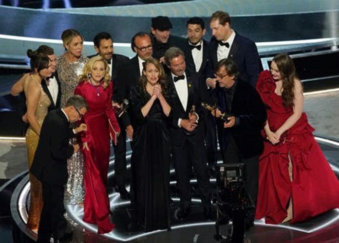 The cast and crew of "CODA" accept the award for best picture at the Oscars on Sunday, March 27, 2022, at the Dolby Theatre in Los Angeles. (AP Photo/Chris Pizzello)