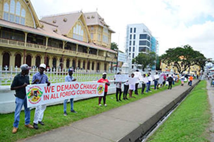 Protestors with their banner and placards in front of the High Court