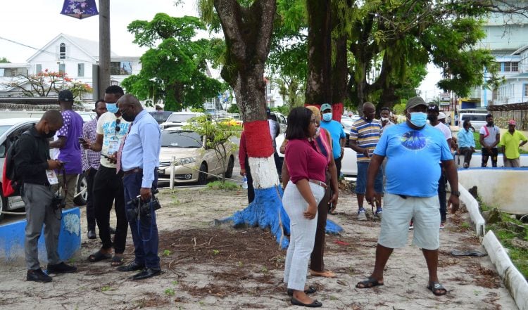 Persons gathered outside of the Brickdam Station following the shooting