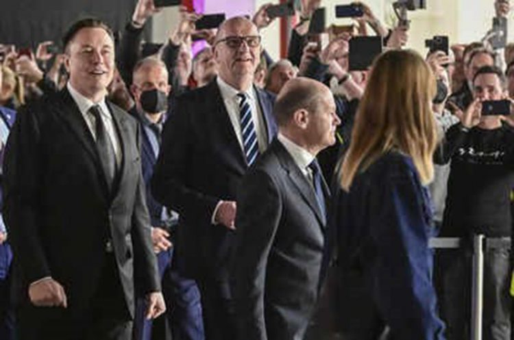 German Chancellor Olaf Scholz (from right), Dietmar Woidke, minister-president of the state of Brandenburg, and Tesla CEO Elon Musk attend the opening of the Tesla factory Berlin Brandenburg in Gruenheide, Germany, Tuesday. (AP)