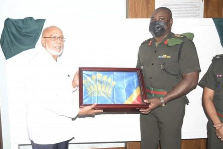 Former President Donald Ramotar (left) formally hands over his Presidential Standard to Guyana Defence Force (GDF) Inspector General, Colonel Knelloyd Roberts for display in the Military Museum at Base Camp Ayanaganna. The standard has been put on display alongside other standards from former presidents Arthur Chung, Forbes Burnham, Desmond Hoyte, Cheddi Jagan and Janet Jagan. The Presidential Standard is a flag used as a symbol of the Head of State of a country. (Guyana Defence Force)