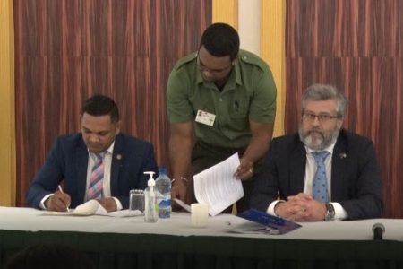 Minister of Natural Resources Vickram Bharrat signs the agreement alongside Ambassador of the European Union to Guyana Fernando Ponz Cantó (DPI photo)
