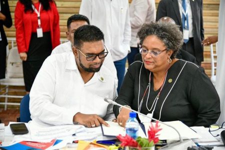 President Irfaan Ali (left) and Barbados Prime Minister Mia Mottley signing the protocol in Belize 