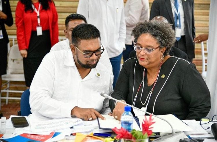 President Irfaan Ali (left) and Barbados Prime Minister Mia Mottley signing the protocol in Belize 