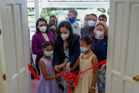 The Minister of Human Services and Social Security, Dr. Vindhya Persaud was joined by two girls to cut the ribbon at the training hall. (MoHSSS photo)
