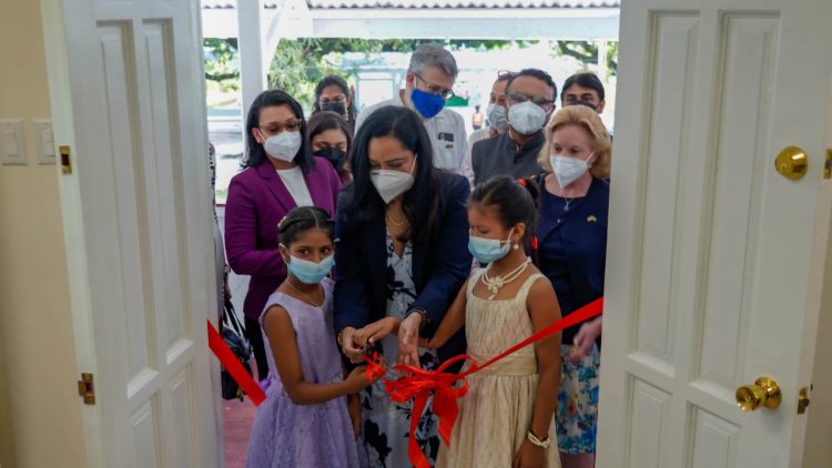 The Minister of Human Services and Social Security, Dr. Vindhya Persaud was joined by two girls to cut the ribbon at the training hall. (MoHSSS photo)
