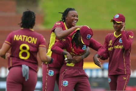 Bowler Chinelle Henry (second from left) hugs Deandra Dottin in celebration after they combined to dismiss Laura Wolvaardt. 