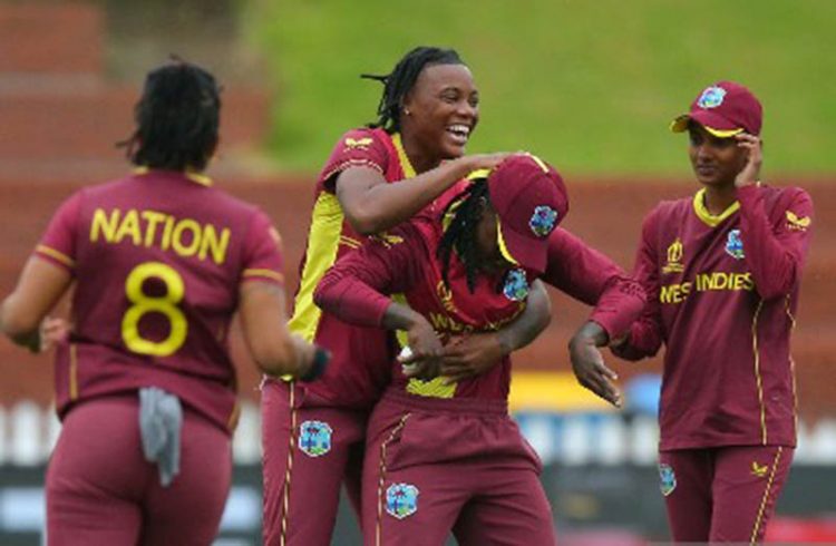 Bowler Chinelle Henry (second from left) hugs Deandra Dottin in celebration after they combined to dismiss Laura Wolvaardt. 