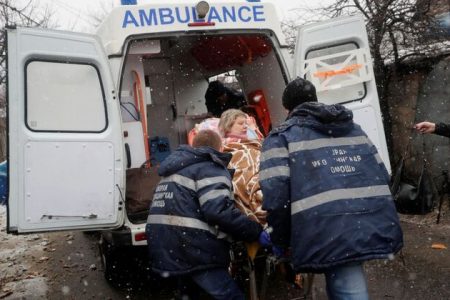 Medical specialists transport an injured woman to an ambulance following recent shelling in the separatist-controlled city of Donetsk, Ukraine March 3, 2022. REUTERS/Alexander Ermochenko