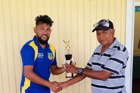 Devendra Bishoo (left) receives his Man-of-the-Match award.
