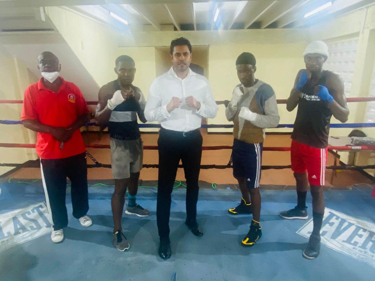 Minister of Sport, Charles Ramson Jr., poses with the selected boxers at the Andrew ‘Six Head’ gym recently.
