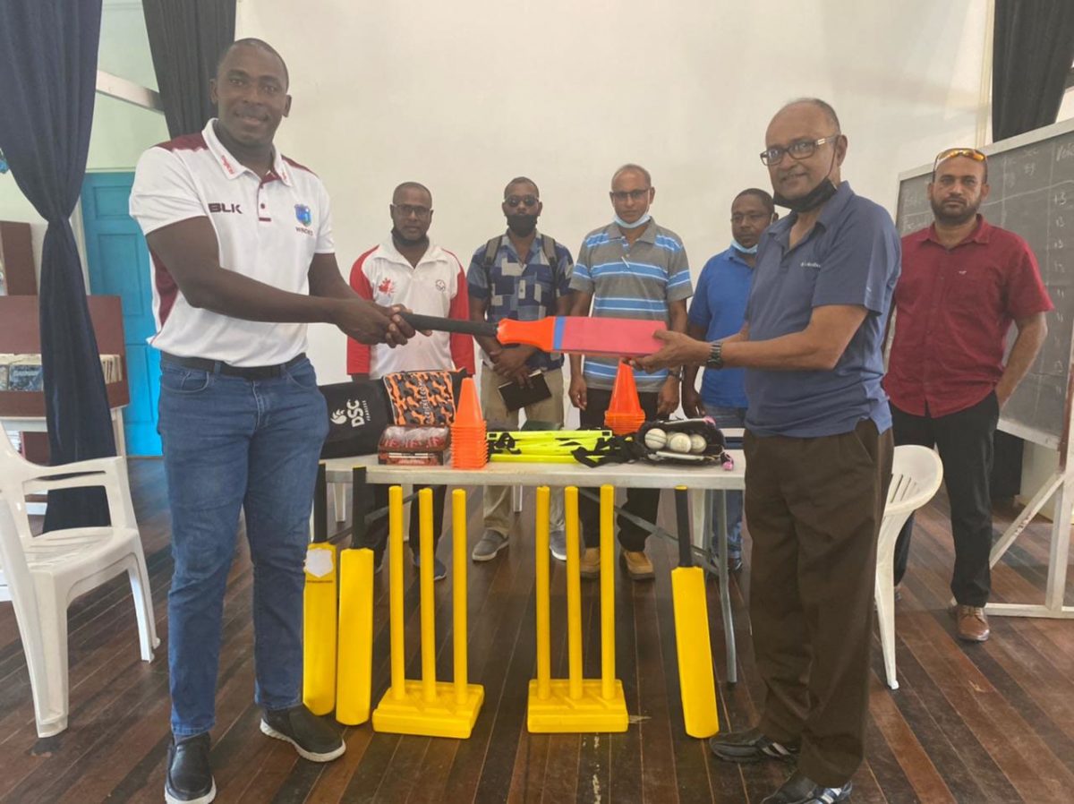 Guyana Harpy Eagles coach Ryan Hercules (left) presents coaching gear to Essequibo Cricket Board president, Deleep Singh.
