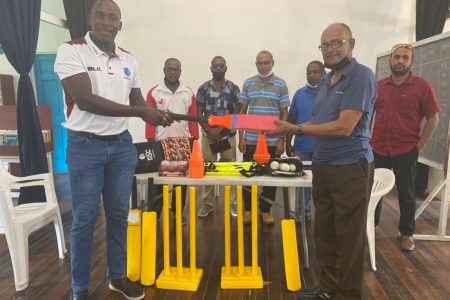Guyana Harpy Eagles coach Ryan Hercules (left) presents coaching gear to Essequibo Cricket Board president, Deleep Singh.
