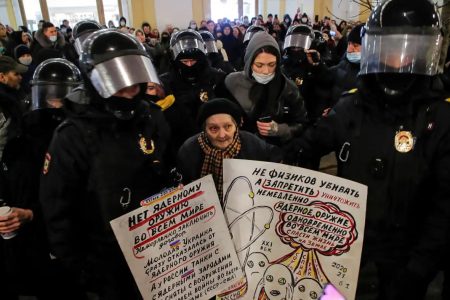 Law enforcement officers escort an elderly artist and activist, Yelena Osipova, during an anti-war protest against Russia's invasion of Ukraine, in Saint Petersburg, Russia March 2