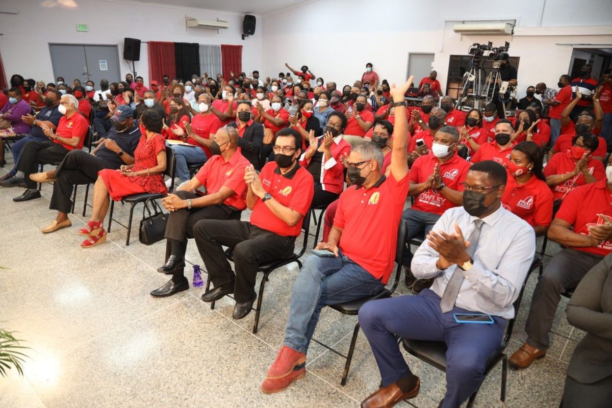 Former agriculture minister Clarence Rambharat, second from right, raises his hand in acknowledgement of Prime Minister Dr Keith Rowley thanking him for his service during the PNM’s meeting in San Fernando last night. (RISHI RAGOONATH)
