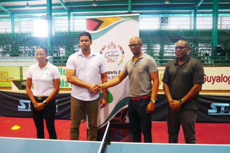 GENTLEMAN’S AGREEMENT? Minister of Sports Charles Ramson Jr., shakes the hand of Guyana Table Tennis Association (GTTA) president Charles Ramson Jr., at yesterday’s Academy launch. At right is Director of Sport, Steve Ninvalle while National Sport Commission’s Cristy Campbell is at left.