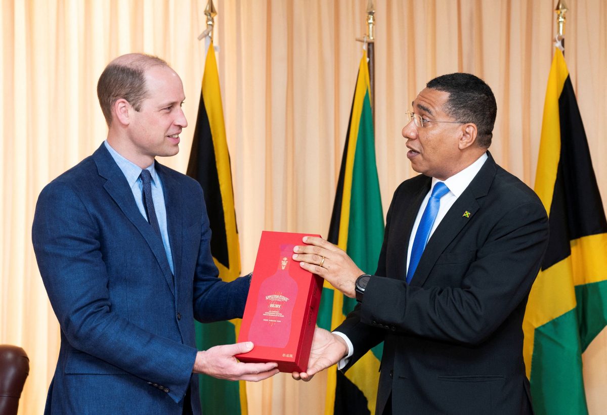 Jamaica's Prime Minister Andrew Holness presents Britain's Prince William with a bottle of Appleton Estate Ruby during a meeting at his office, on day five of the Platinum Jubilee Royal Tour of the Caribbean, in Kingston, Jamaica, March 23, 2022. Jane Barlow/Pool via REUTERS