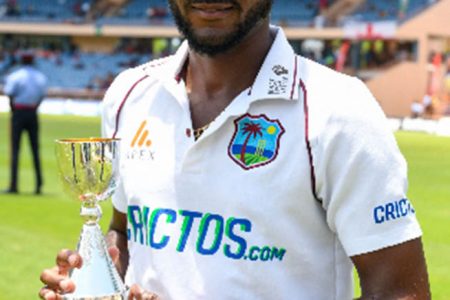 Captain Kraigg Brathwaite poses with the Richards-Botham Trophy on Sunday following West Indies’ series win.
