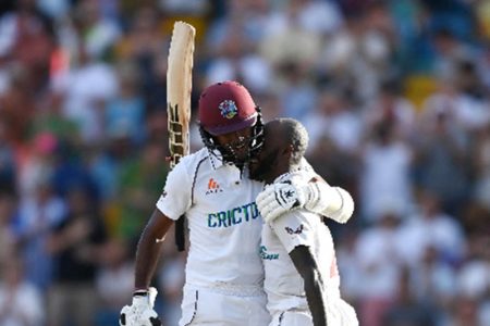 Captain Kraigg Brathwaite (left) embraces Jermaine Blackwood after the Jamaican completed his third Test hundred yesterday. (Photo courtesy CWI Media)