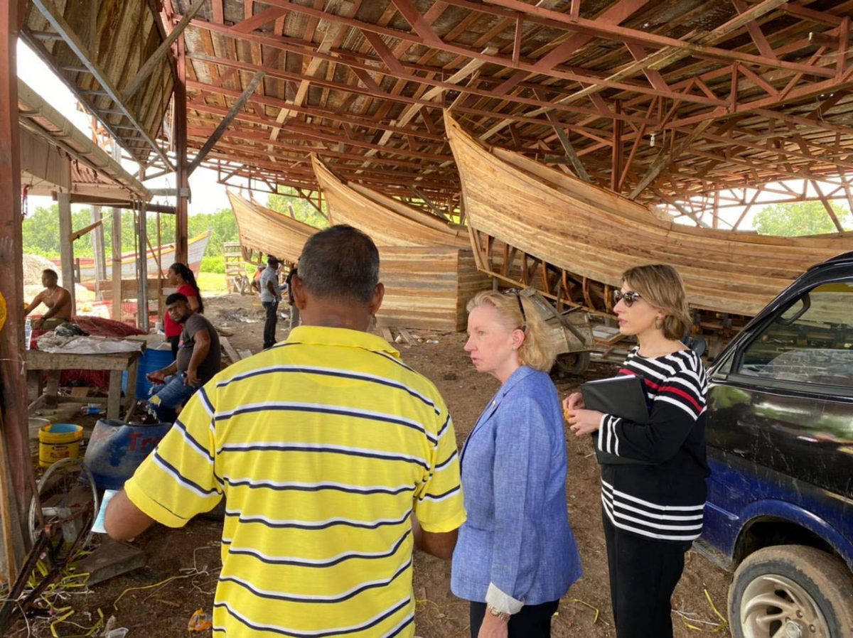 Checking in with fishermen: US Ambassador to Guyana, Sarah-Ann Lynch (second from right) and US Deputy Assistant Secretary Barbara Feinstein (right) travelled to regions 5 & 6 to speak with local fishermen, the Upper Corentyne Chamber of Commerce, and see agro-businesses in action. Fishing boats under construction can be seen in the background. Feinstein, who has responsibility for Carib-bean Affairs and Haiti was here last week for three days during which she met with the government, the opposition and civil society bodies.  (US Embassy photo)