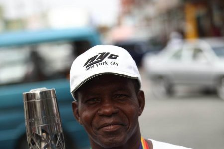FLASHBACK! Guyana’s Olympic bronze medallist Michael Anthony Parris with the Queen’s Baton in 2018.