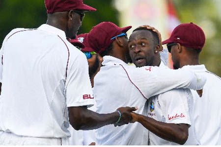 Kemar Roach (second from right) and West Indies celebrate a wicket during the 2019 series against England.