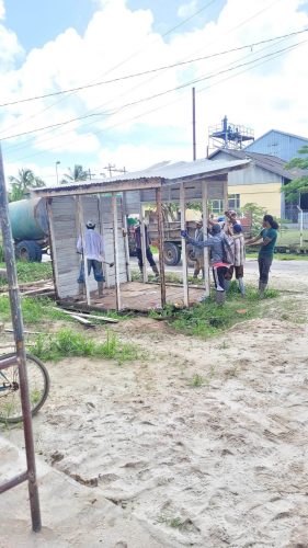 Workers dismantling a stall built over the drainage system at Charity