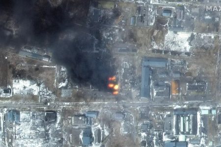This Maxar satellite image taken and released on March 12, 2022, shows a multispectral view of fires in an industrial area of the Primorskyi district in western Mariupol, Ukraine. (AFP)