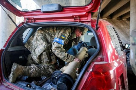 Tetiana Chornovol, former member of the Ukrainian Parliament, now a service member and operator of an anti-tank guided missile weapon system, pulls an anti-tank missile out of a car at a position on the front line in the Kyiv region, Ukraine, March 20, 2022. REUTERS/Gleb Garanich