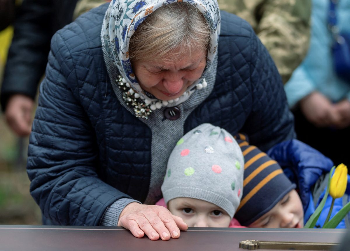 Maria, wife of a Ukrainian soldier Vasyl Vekliuk, 59, who died in a shelling near Popasna in the Luhansk region, amid Russia’s invasion of Ukraine, attends his funeral in Stebnyk, Lviv region, Ukraine, March 30, 2022. REUTERS/Viacheslav Ratynskyi