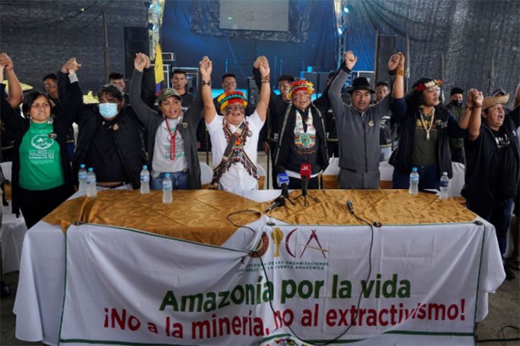 Leaders from indigenous communities in the Amazon basin gesture at a news conference behind a banner reading “Amazon for life, No to mining, No to extraction” during a meeting where they demanded South American governments halt extractive industries that damage the rainforest, in Union Base, Ecuador March 15, 2022. (REUTERS/Johanna Alarcon photo)