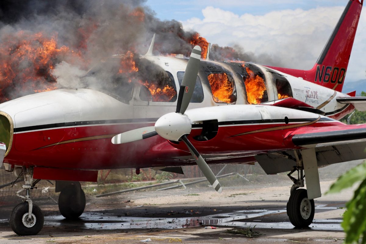 A plane belonging to U.S. missionary group Agape Flights burns after it was set on fire during protests demanding that the government of Prime Minister Ariel Henry do more to address gang violence including constant kidnappings, in Les Cayes, Haiti March 29, 2022. REUTERS/Duples Plymouth