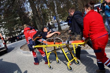 Medics move a wounded soldier, following an attack on the Yavoriv military base, amid Russia's invasion of Ukraine, at a hospital in Yavoriv, Ukraine, March 13, 2022. REUTERS/ Kai Pfaffenbach